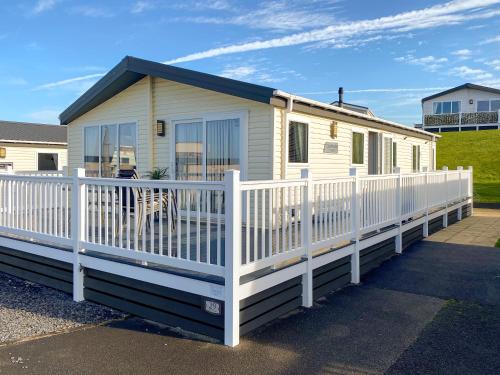 ランカスターにあるSunset Lodgeの白い柵のある移動式住宅