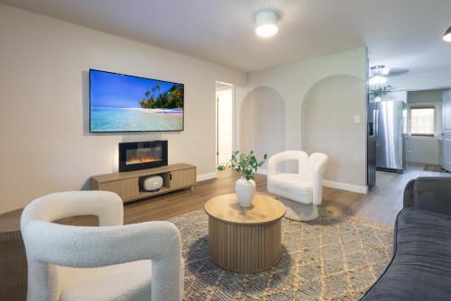 a living room with a couch and a tv at Biva Luxe in West Palm Beach
