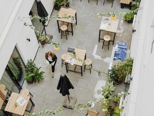 an overhead view of a restaurant with tables and chairs at INK Hotel Amsterdam - MGallery Collection in Amsterdam