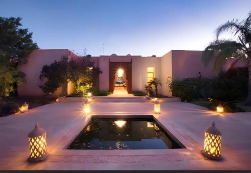 a house with a pool in the middle of a yard at Villa Serenity Marrakech in Châba