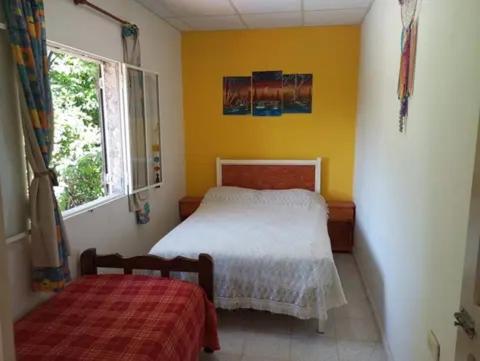 a small bedroom with a bed and a window at Casatanti in Tanti