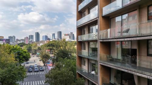an apartment building with a view of a city at MEDELLIN by Mr W in Mexico City