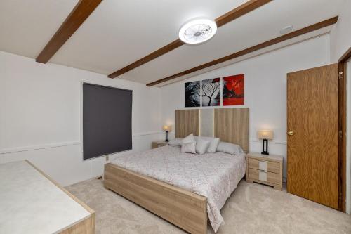 a bedroom with a bed and a flat screen tv at Peaceful 3BR Retreat - Near Statesville in Statesville