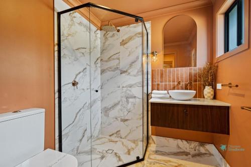 a bathroom with a shower and a sink at Roy and Estelles by Discover Stradbroke in Amity Point