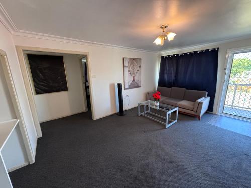 a living room with a couch and a table at Apartments on Turf Unit 3 in Grafton