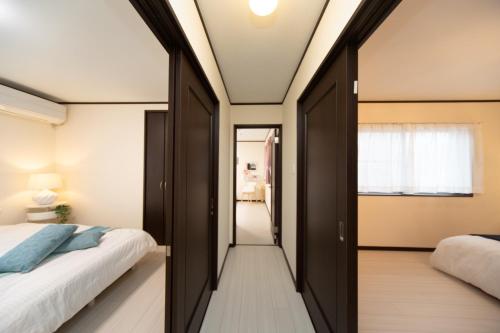 a bedroom with two beds and a hallway at Awaji Central in Kuruma - Vacation STAY 66482v in Awaji