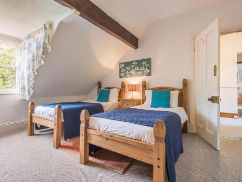 a bedroom with two beds and a window at 6 Bed in Braithwaite SZ044 in Braithwaite