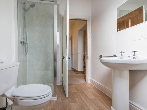 a bathroom with a toilet and a sink and a shower at 6 Bed in Braithwaite SZ044 in Braithwaite