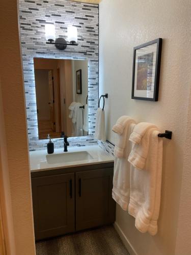 a bathroom with a sink and a mirror and towels at Blue Bear - Perfect Mountain Getaway in Idaho Springs