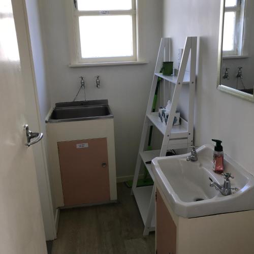 a bathroom with a sink and a mirror and a sink at The Bivvy at Hutt Central in Lower Hutt