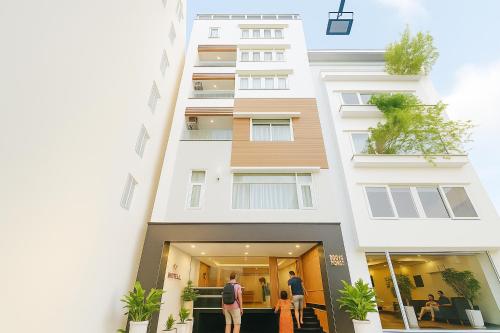 a building with people standing outside of it at Diamond Luxury Ben Thanh in Ho Chi Minh City