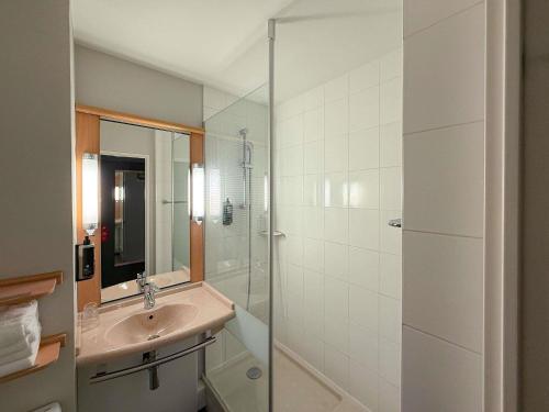 a bathroom with a sink and a shower at ibis Rennes Cesson in Cesson-Sévigné