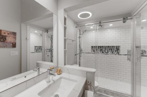 a white bathroom with a sink and a shower at Lake Cliffe #305 Building A in Dillon