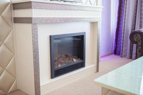 a fireplace with a fire place in a living room at Astoria in Mykolaiv