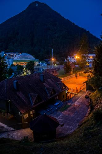a view of a city at night with a mountain at Penzion Park in Laško