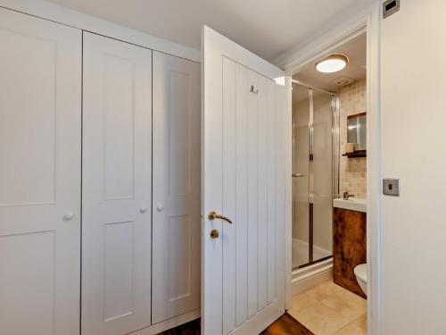 a white bathroom with a shower and a toilet at 2 Bed in Ravenglass 95884 in Ravenglass