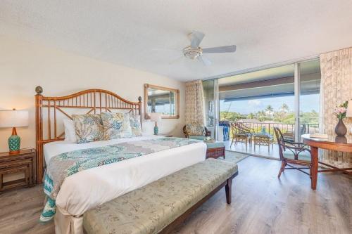 a bedroom with a large bed and a balcony at Eldorado K203 · EL K203 2BD Condo w AC Pool Beach Cabana in Kahana