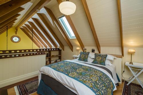 a bedroom with a king sized bed in a attic at Old Bank Boutique Hotel in Mittagong