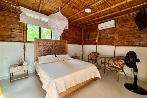 a bedroom with a bed and a table and chairs at Agencia Ecohuila in Villavieja
