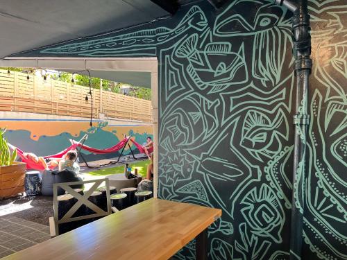 a room with a wall with a painting on it at Polynesian Hostel Beach Club in Honolulu