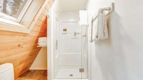 a bathroom with a shower with a glass door at Sleeps 20 2 Homes Near Ski Resort Beach Lake Access Pool Homewood in Tahoma Meadows