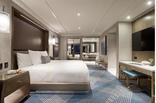 a bedroom with a large bed and a bathroom at The Star Grand at The Star Gold Coast in Gold Coast