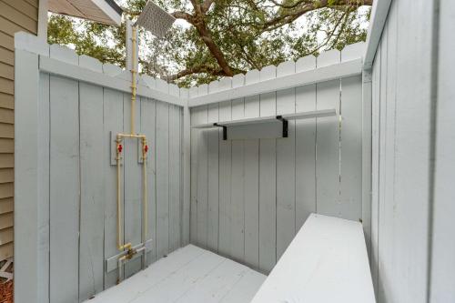 a privacy fence with a shower in a backyard at The Backyard Glampground - Camper Fire Pit & Games in Tampa
