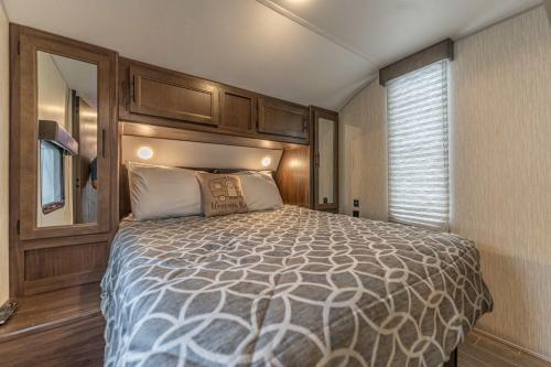 a bedroom with a large bed in a room at The Backyard Glampground - Camper Fire Pit & Games in Tampa