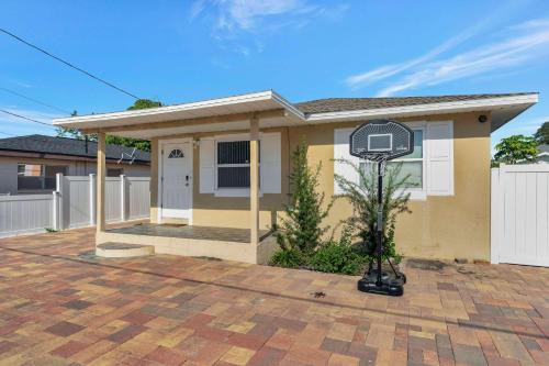 a house with a basketball hoop in front of it at Sunny Tampa Home Near Downtown & Stadiums in Tampa