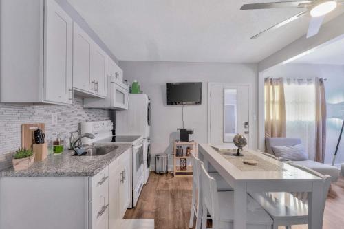 a kitchen with white cabinets and a white counter top at Sunny Tampa Home Near Downtown & Stadiums in Tampa