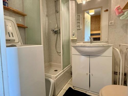 un bagno bianco con lavandino e doccia di Appartement cosy avec terrasse et parking proche centre - FR-1-505-235 a Notre-Dame-de-Bellecombe