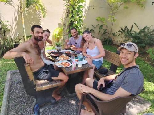 a group of people sitting around a picnic table at Eolie Weligama in Weligama