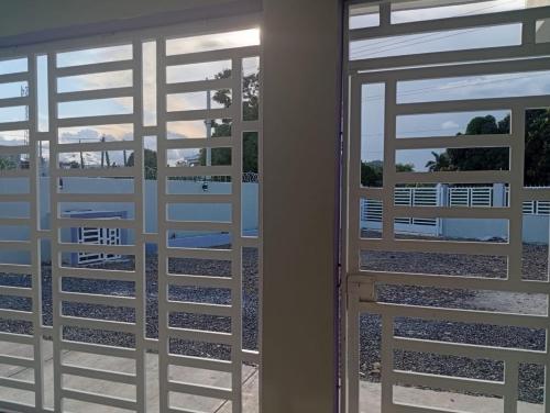 a pair of doors with a view of a patio at Villa colombia in Miches
