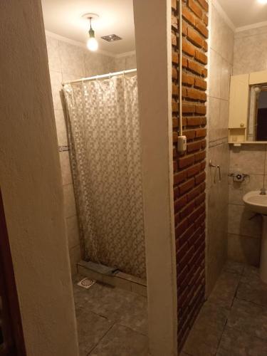 a bathroom with a shower and a sink at La Casa de Doña Adela in Eugenio Bustos