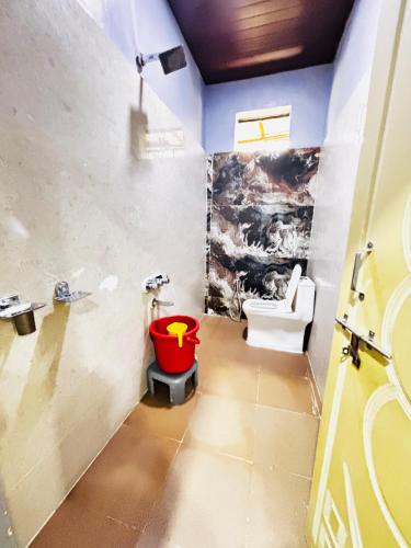 a bathroom with a toilet and a sink at Reddy home stay in Hampi