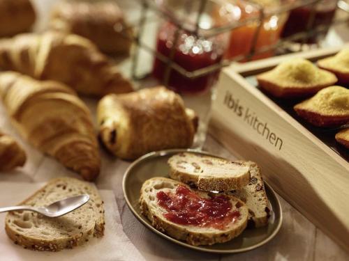 a plate of toast with jam on a table with bread at ibis Utrecht in Utrecht