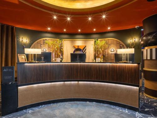 a lobby of a hotel with a bar at Nest Hotel Paris la Défense - MGallery Collection in Puteaux