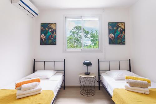 Ένα ή περισσότερα κρεβάτια σε δωμάτιο στο Evasion tropicale et sérénité à la Villa DitAlbè