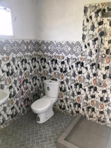 a bathroom with a toilet and a sink at Kingz and Queenz - Negombo in Negombo