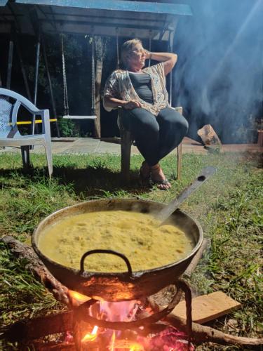 PanaotiBalthali Heritage Inn的坐在火旁椅子上的女人