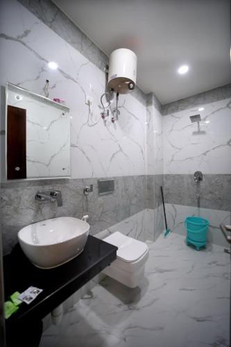 a bathroom with a sink and a toilet at Hotel Royal Phoenix in Agra