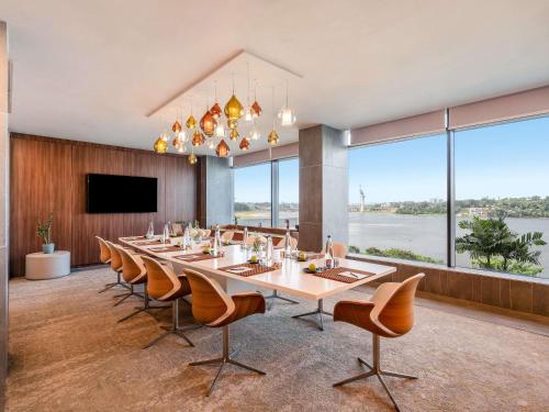 a large dining room with a long table and chairs at Pullman Abidjan in Abidjan