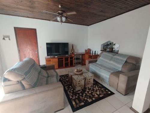 a living room with a couch and a tv at Apartamento moderno y luminoso ,con 2 dormitorios in Rivera