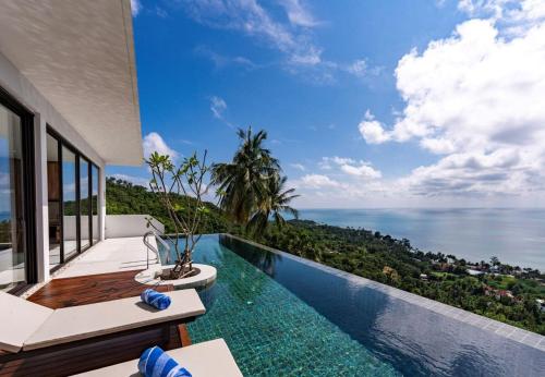 a swimming pool with a view of the ocean at Anzhu Seamate Villa Samui in Lamai