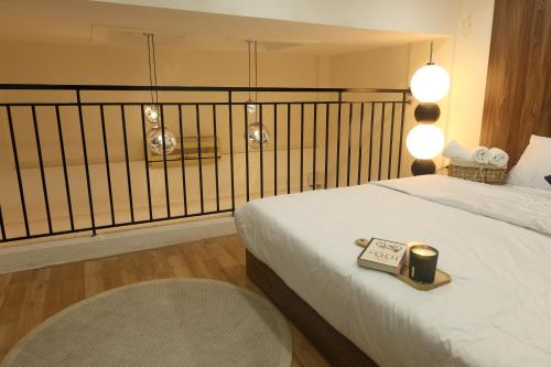 a bedroom with a bed with a clock on it at Dfour Home Ngõ Gạch - Old Quarter in Hanoi