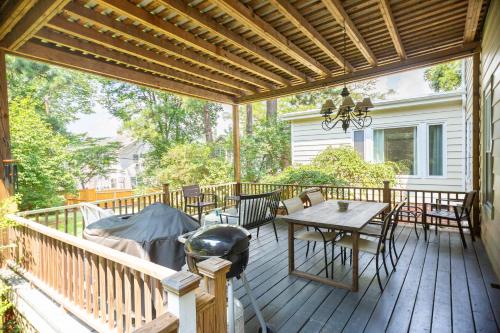 a porch with a table and chairs on a deck at Spacious 2BR in Grand Old Home, Downtown Durham in Durham