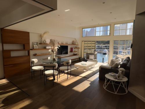 a large living room with a table and chairs at Harbour View Woolloomooloo in Sydney