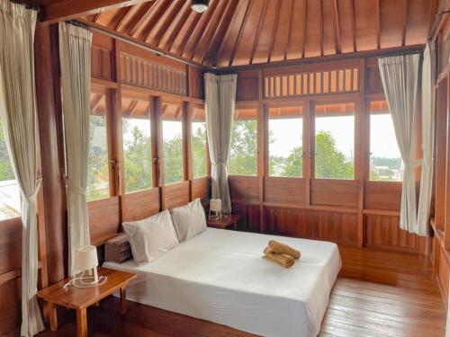 a bedroom with a bed with a teddy bear on it at Arovala Villa in Padasul