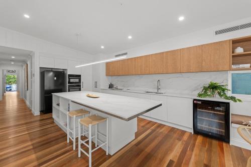 a kitchen with white countertops and a fireplace at The Coterie Fortitude Valley in Brisbane