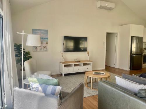 a living room with a couch and a table at The Salty Olive - WiFi Pet Friendly Outside in Robe